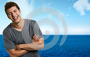 Smiling relaxed man at the beach in a summer day