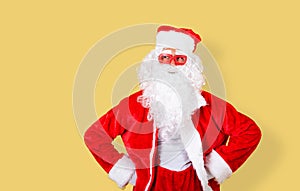 Smiling and relaxed Santa Claus with modern red glasses looking to the copy space