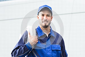 Smiling Repairman With Toolbox And Cable