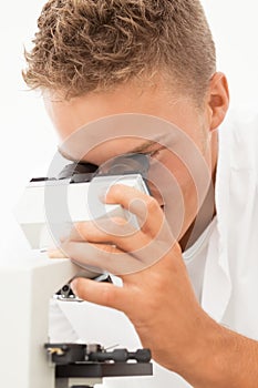 Smiling researcher with microsope