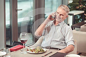 Smiling retired man relaxing in a restaurant