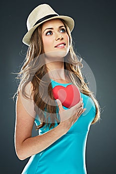 Smiling romantic woman hold red heart . long hair