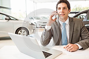 Smiling salesman having a phone call