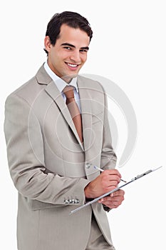 Smiling salesman with notepad and pen