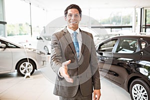 Smiling salesman ready to shake hand