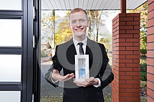 Smiling salesman selling perfume