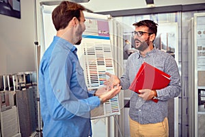 Smiling salesmen with customer