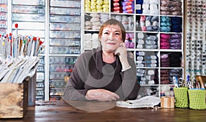 Smiling saleswoman is working at table