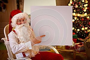 Smiling Santa Claus pointing in empty banner