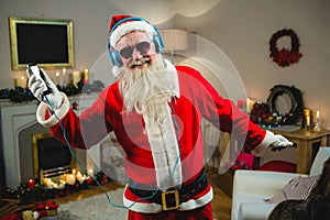 Smiling of santa claus singing a christmas songs at home