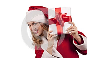 Smiling Santa emerge from behind a gift box photo