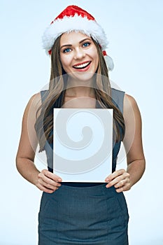 Smiling Santa girl business woman holding white blank advertising banner.