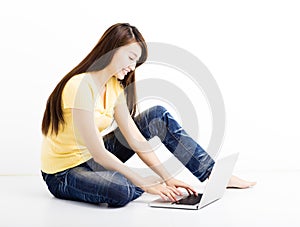 Smiling seated young woman with laptop