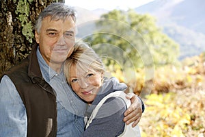 Smiling senior couple embracing in forest