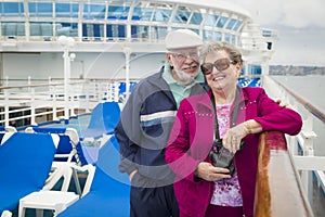 Smiling Senior Couple Enjoying The Deck of a Cruise Ship