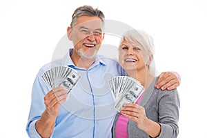 Smiling senior couple holding money