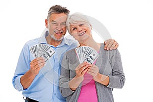 Smiling senior couple holding money