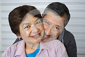 Smiling senior couple hugging.