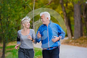 Smiling senior couple jogging in the park