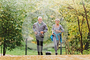 Smiling senior couple jogging in the park