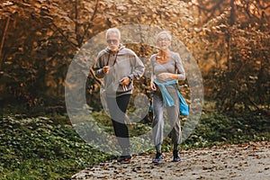 Smiling senior couple jogging in the park