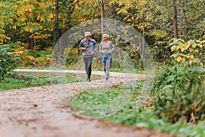 Smiling senior couple jogging in the park