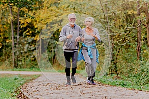 Smiling senior couple jogging in the park