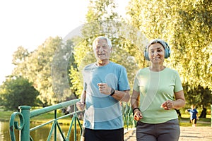 Smiling senior couple jogging in the park