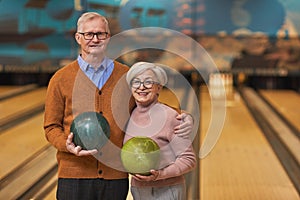 Smiling Senior Couple Posing at Bowling Alley