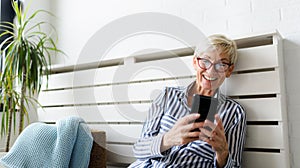 Smiling senior couple sitting in the park talking