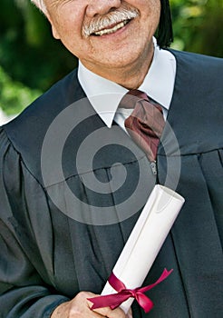 Smiling Senior Graduate holding diploma