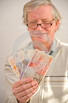 Smiling senior holding winnings. photo