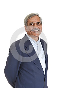 Smiling Senior Indian businessman or executive in a light blue shirt and dark blue suit