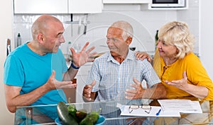 Smiling senior male and female with son at home interior