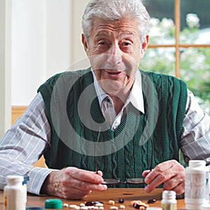 Smiling senior man with many pills