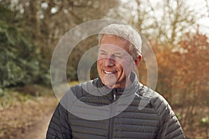 Smiling Senior Man On Walk In Autumn Countryside Exercising During Covid 19 Lockdown