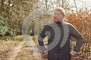 Smiling Senior Man On Walk In Autumn Countryside Exercising During Covid 19 Lockdown