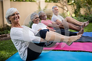 Smiling senior people exercising with feet up