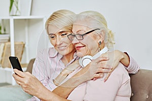 Smiling Senior Woman with Adult Daughter at Home