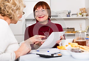 Smiling senior women with documentation