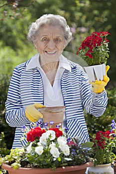 Smiling Senior Woman Holding Flowers