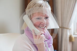 Smiling Senior Woman Making Phone Call At Home