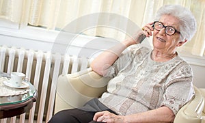 Smiling senior woman talking on mobile phone.