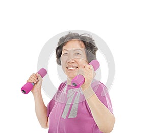 Smiling senior woman working out with dumbbells