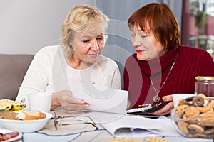 Smiling senior women with documentation