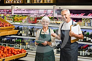 Smiling senior workers with clipboard