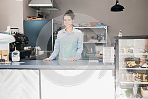 Smiling Shopkeeper Behind Counter