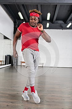 Smiling short-haired dark-skinned man wearing bright comfy outfit photo