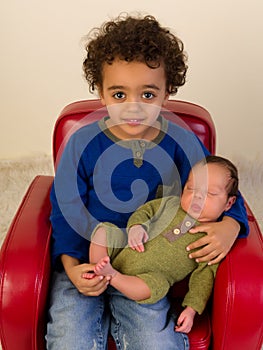 Smiling sibling with newborn brother