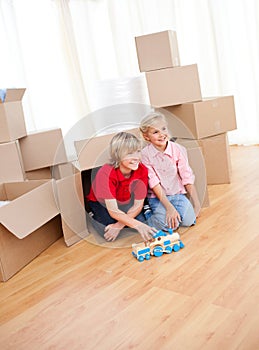 Smiling sibling playing while moving house